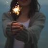 Image of a woman holding a sparkler.