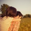 Picture of a couple with the man giving his woman a piggy back