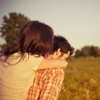 Picture of a couple with the man giving his woman a piggy back