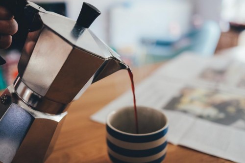 Image of someone pouring coffee into a cup